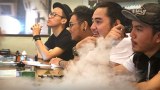 Young men vape in an inner-city vape bar in Jakarta, Indonesia