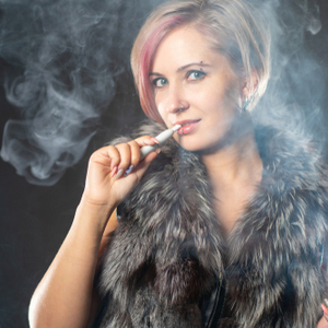 woman vapourizing heated tobacco
